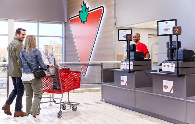 Couple shopping at a Canadian Tire store with shopping cart 