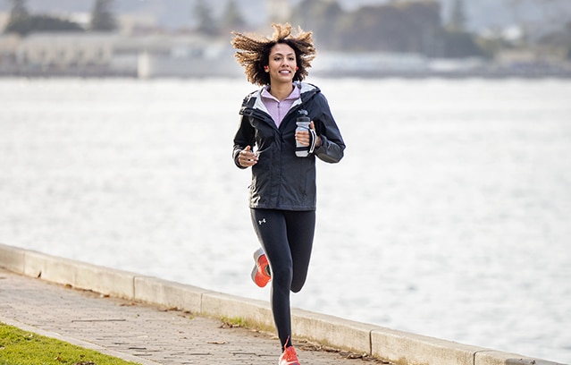 Women jogging outside in athletic clothing 