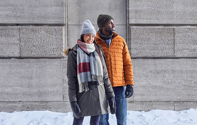 Two people outside in Marks winter clothing 